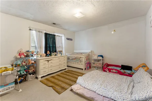 a bed room with a bed and a window