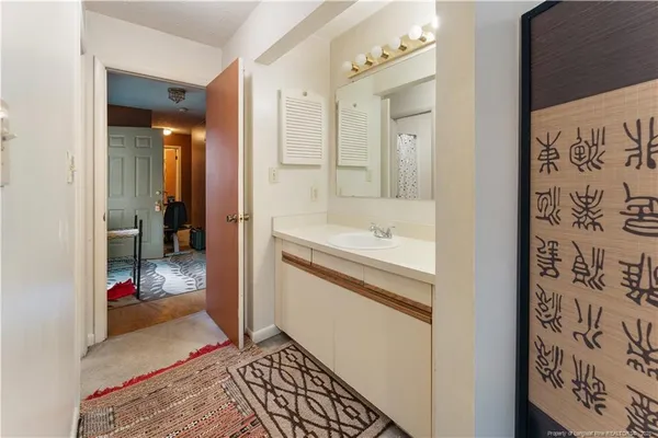 a bathroom with a tub shower and sink