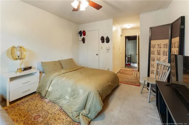 a spacious bedroom with a bed and a chandelier