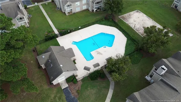 an aerial view of a house with a garden and trees