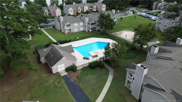 an aerial view of a house with outdoor space pool seating area and yard