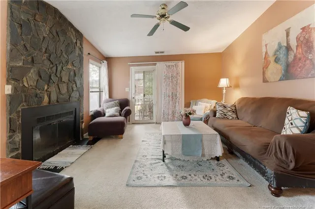 a living room with furniture and a fireplace