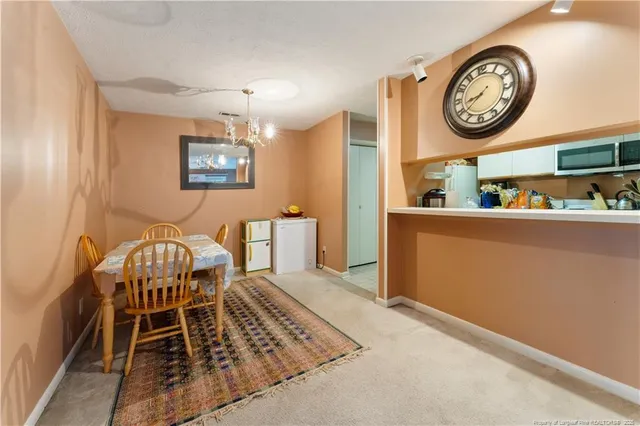 a view of a dining area with furniture and a clock