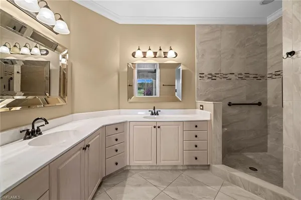 a spacious bathroom with double sink and a mirror