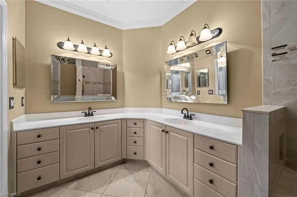 a bathroom with a double vanity sink mirror and