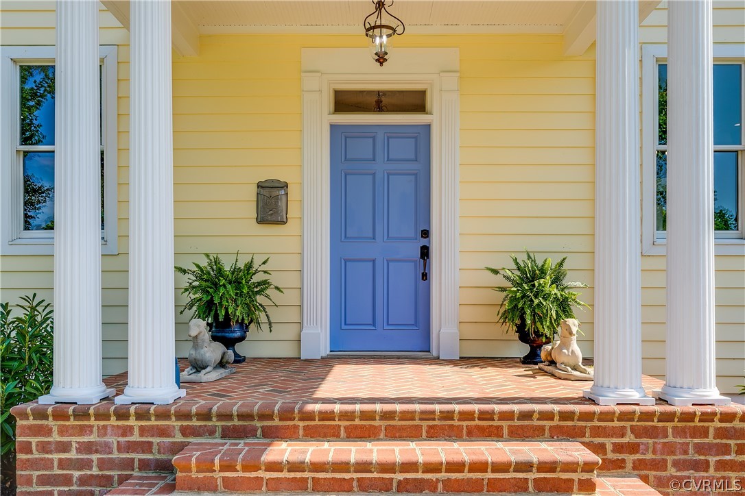 1720 Norwood Road Bruington, VA 23023 - Photo 5 of 50 a house with a potted plant in front of door