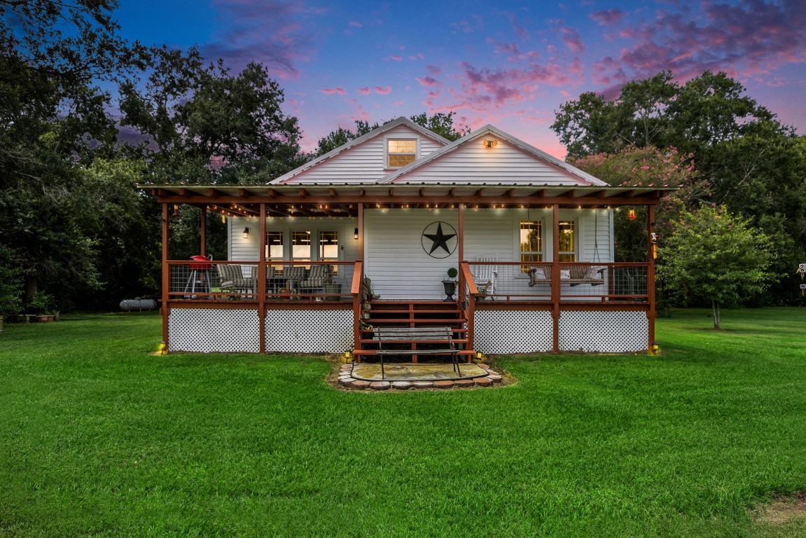 a front view of a house with a garden and swimming pool