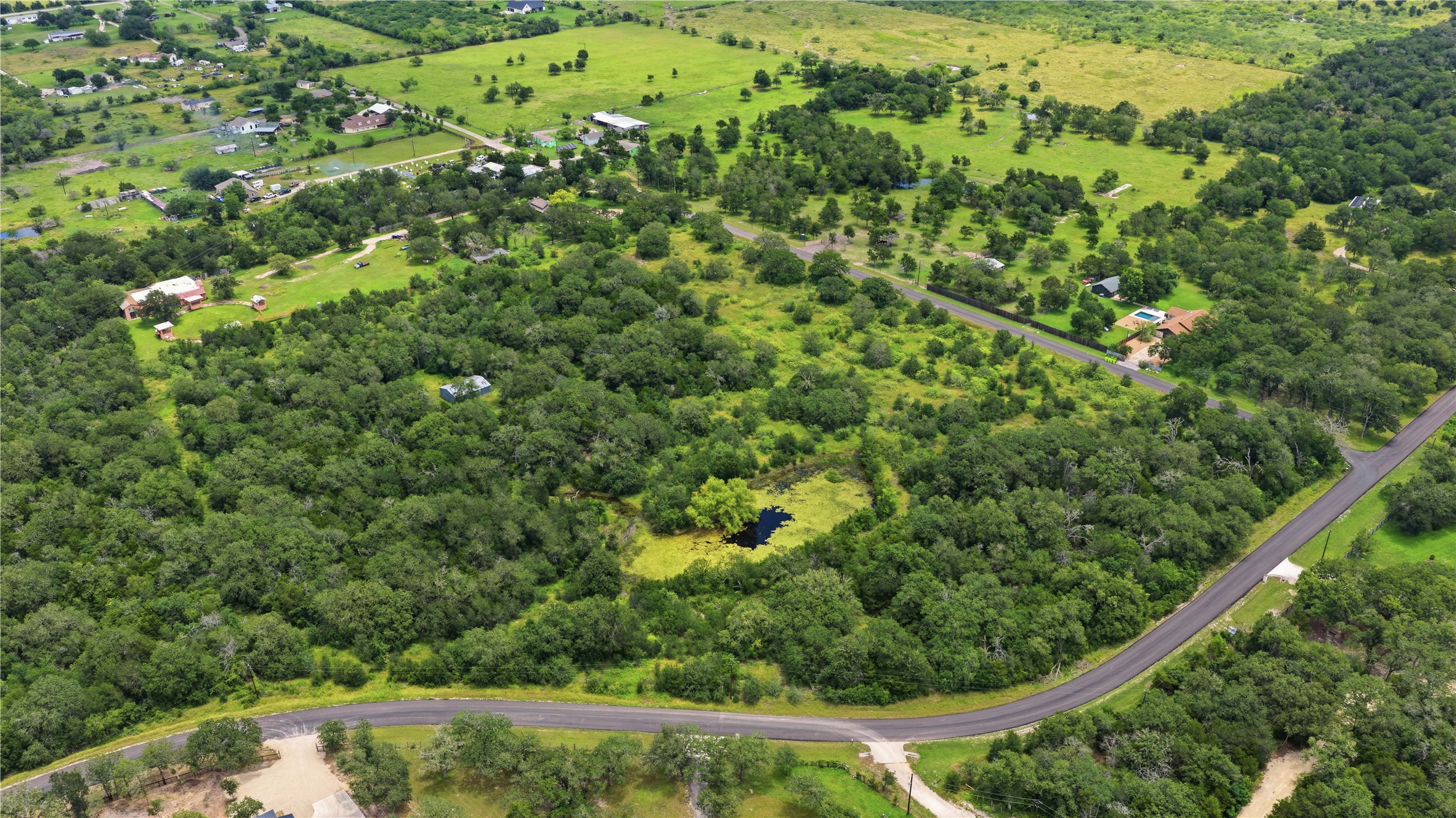 10312 Parsons Road Manor, TX 78653 - Photo 4 of 26 Discover vast, verdant landscapes surrounding a tranquil, private pond.