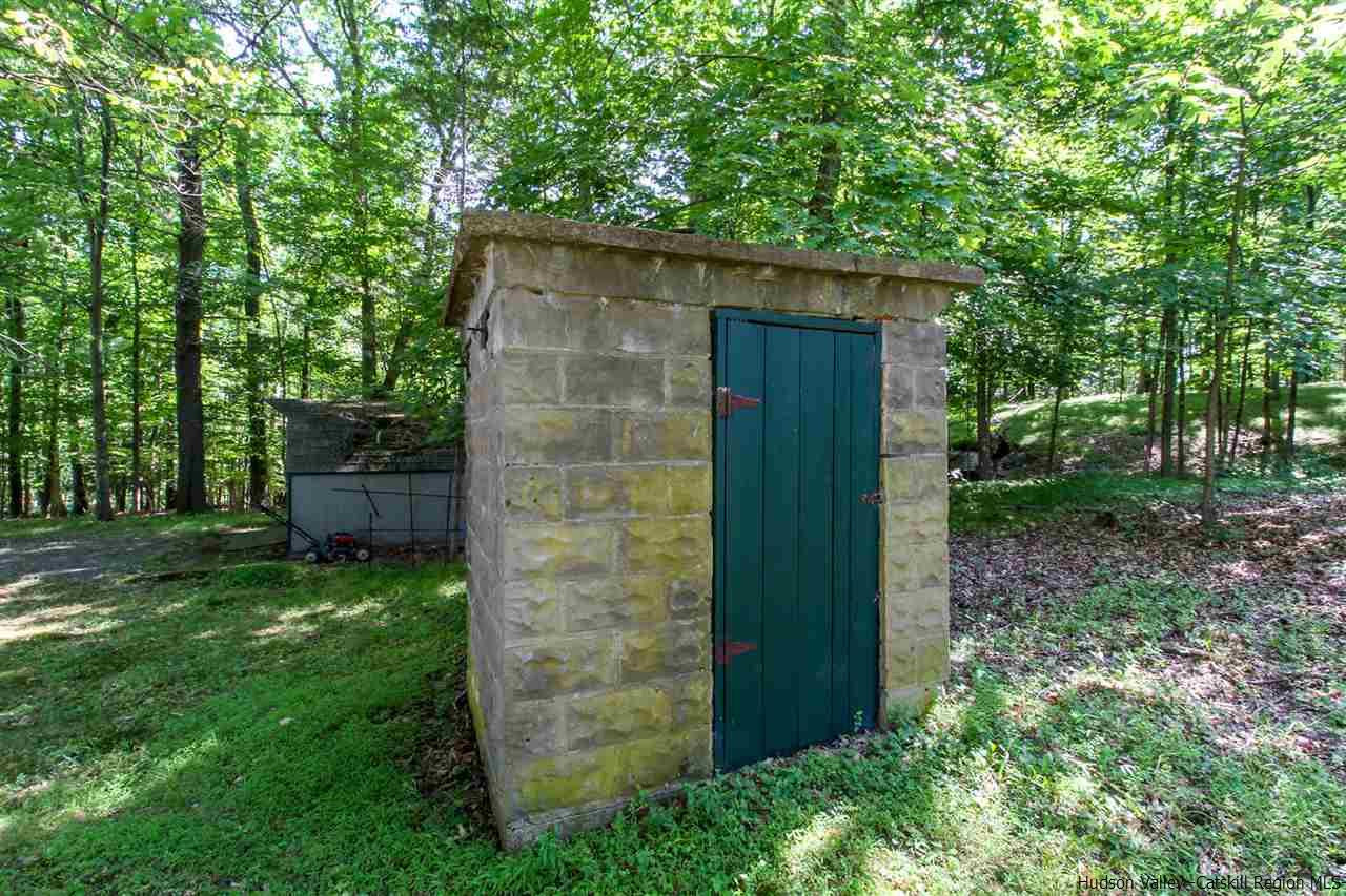 51 Vly Atwood Road Stone Ridge, NY 12484 - Photo 18 of 19 a backyard of a house with plants and outdoor seating