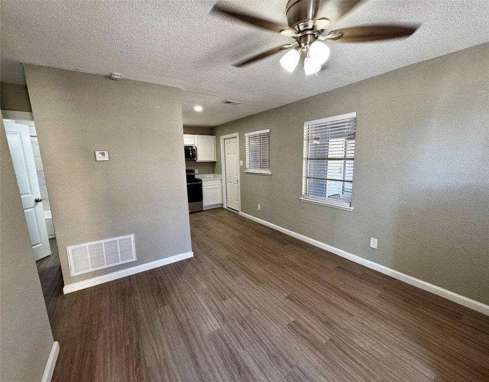 202 West N Loop Boulevard, Unit A Austin, TX 78751 - Photo 3 of 6 wooden floor in an empty room with a window