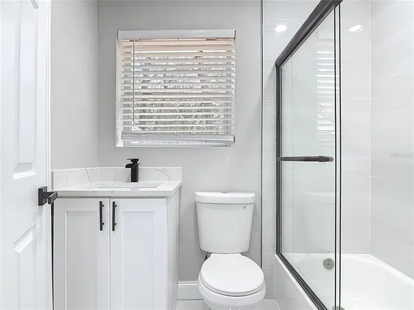 a white toilet sitting next to a bathroom sink