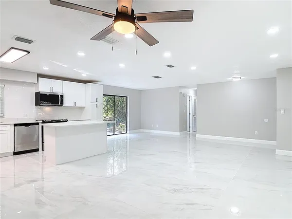 a view of a kitchen with a sink and microwave