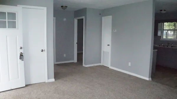 a view of an empty room with a bathroom