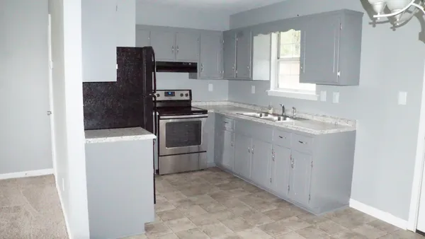 a kitchen with a sink stove and refrigerator