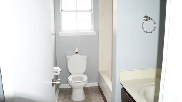 a white toilet sitting next to a bathroom sink