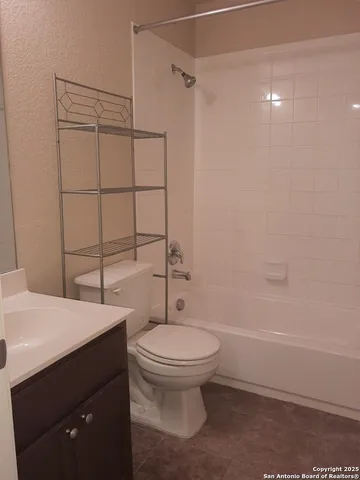 a bathroom with a toilet a sink and shower