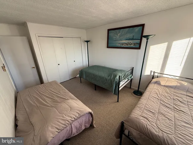 a bedroom with bed and a window