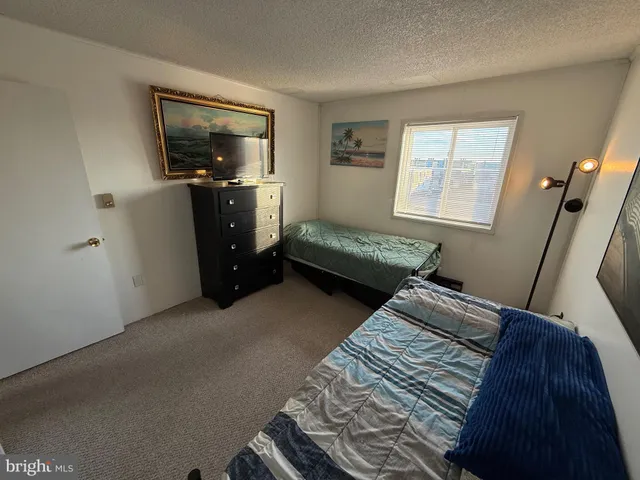 a bedroom with bed and window