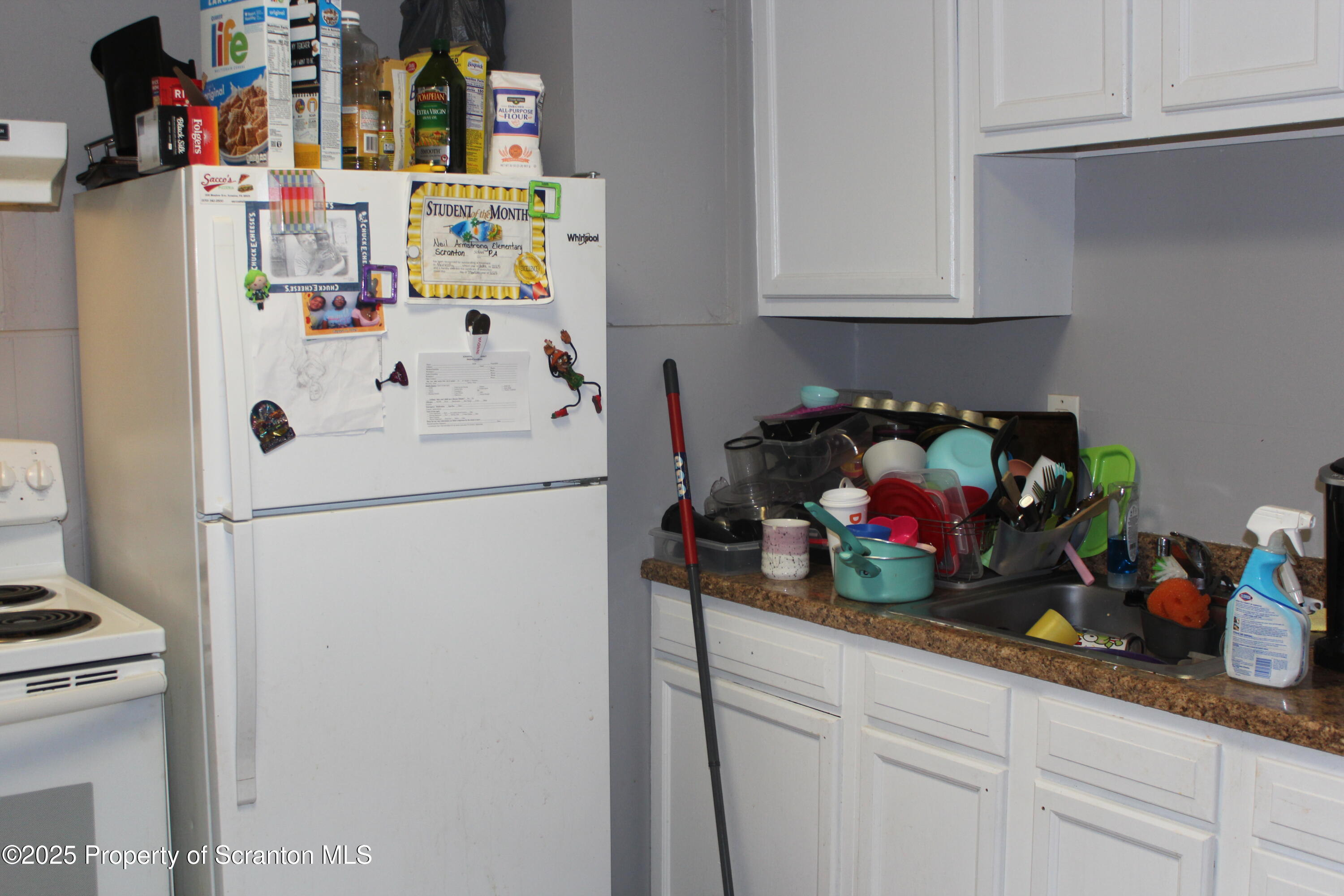 333 Spring Street Scranton, PA 18508 - Photo 14 of 43 a white kitchen with a refrigerator and a stove