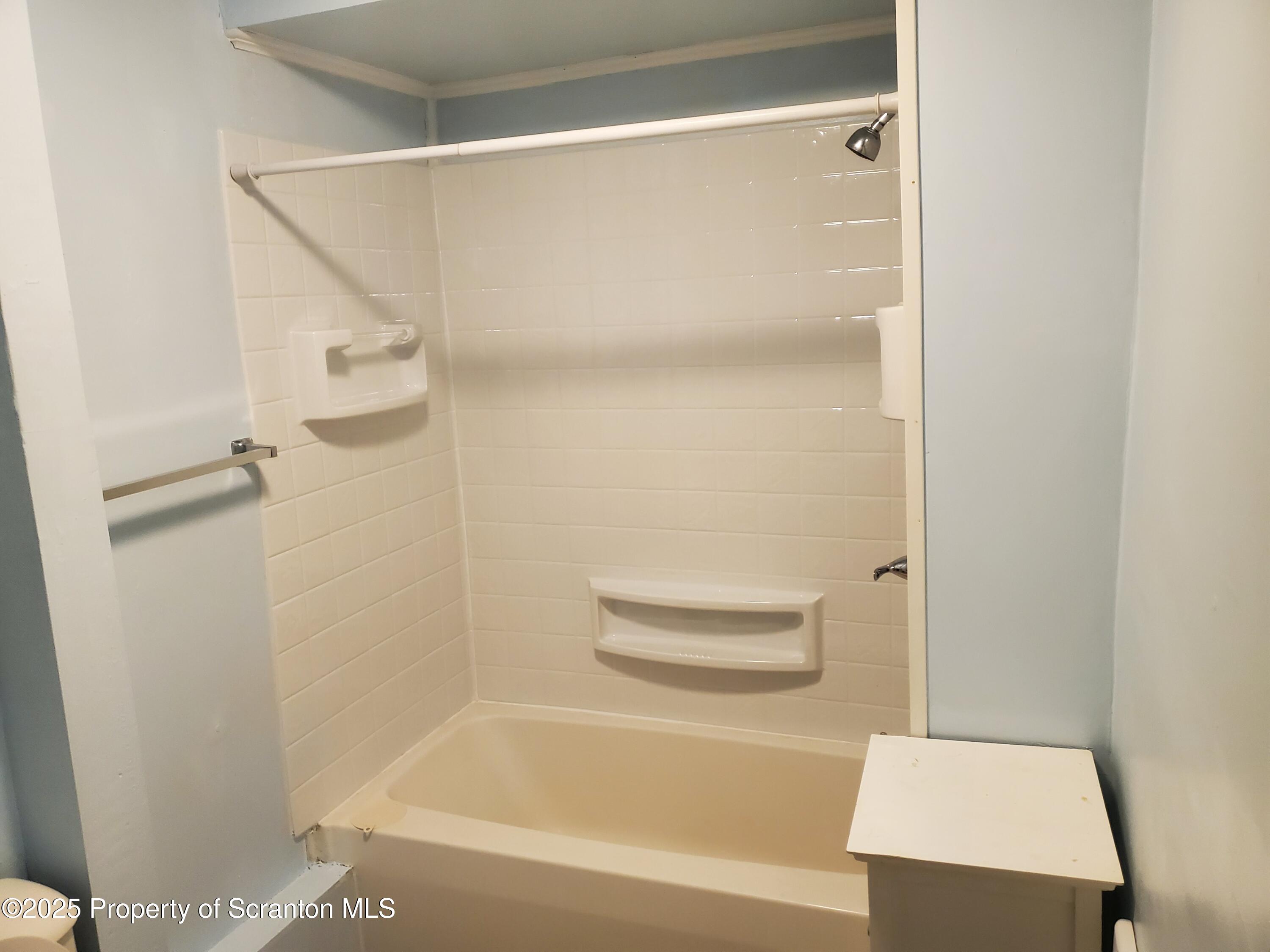 333 Spring Street Scranton, PA 18508 - Photo 19 of 43 a bathroom with a bathtub and a shower