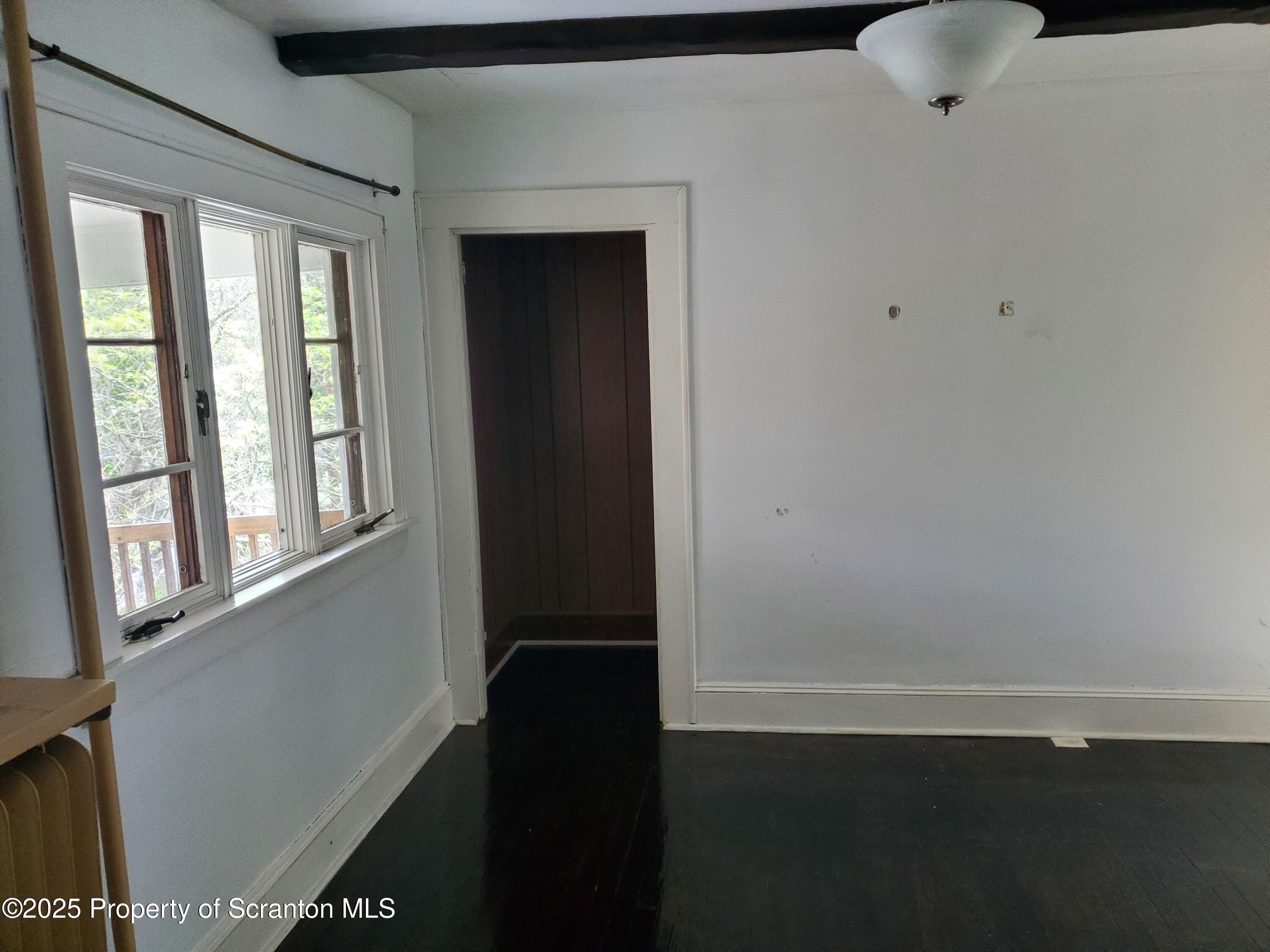 333 Spring Street Scranton, PA 18508 - Photo 22 of 43 a view of an empty room with wooden floor and a window