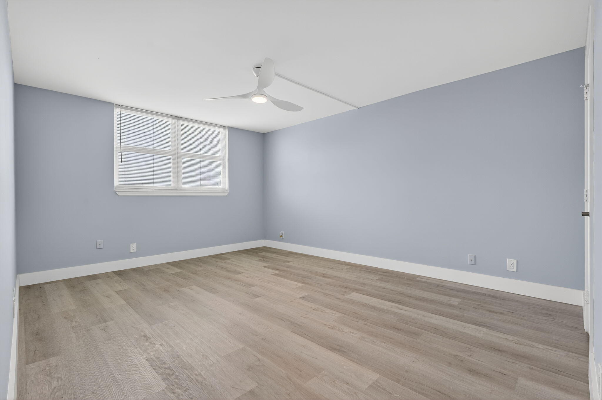 5500 Northwest 2nd Avenue, Unit 314 Boca Raton, FL 33487 - Photo 15 of 35 an empty room with wooden floor and windows