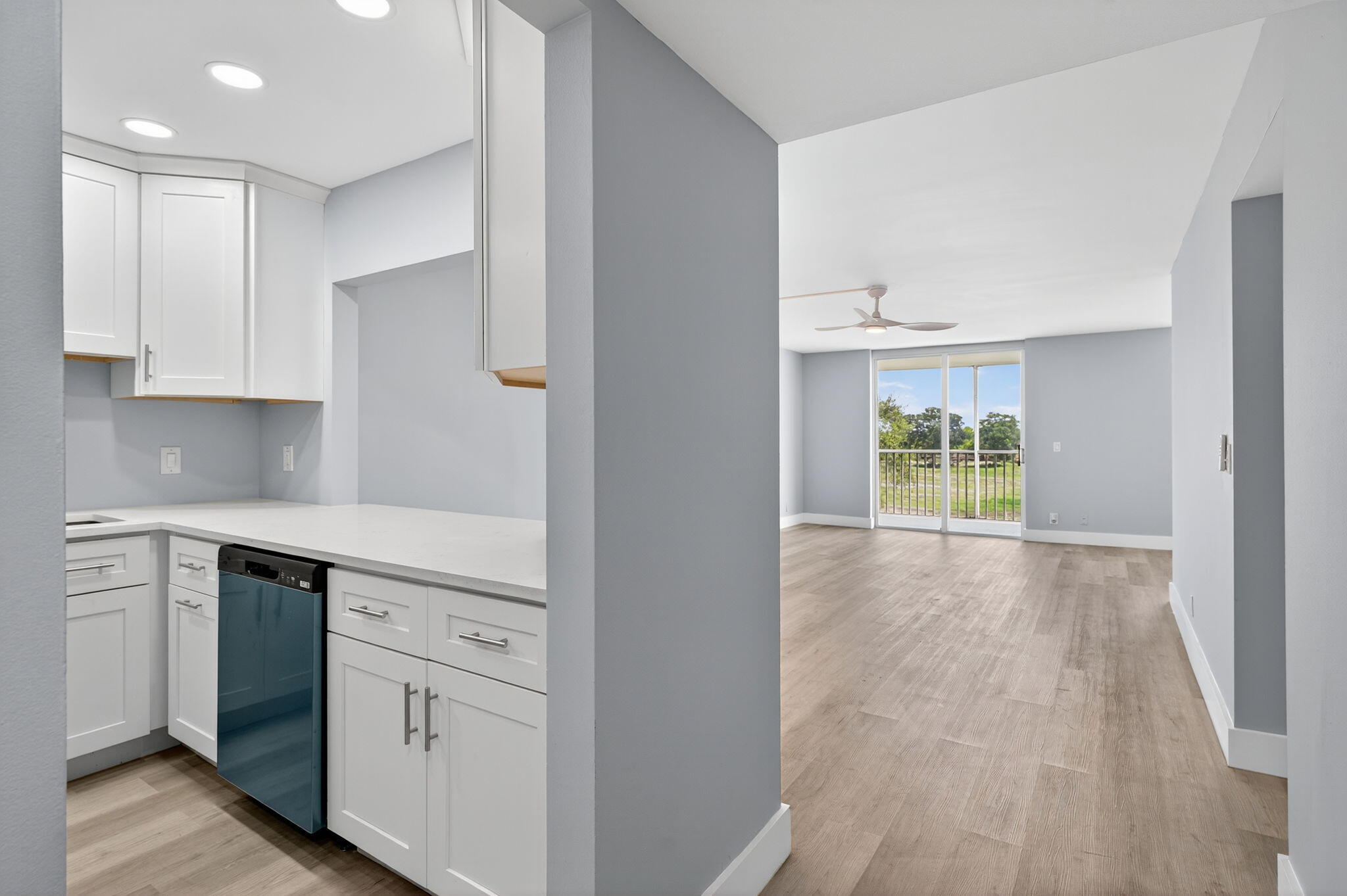 5500 Northwest 2nd Avenue, Unit 314 Boca Raton, FL 33487 - Photo 2 of 35 a kitchen with white cabinets and wooden floor