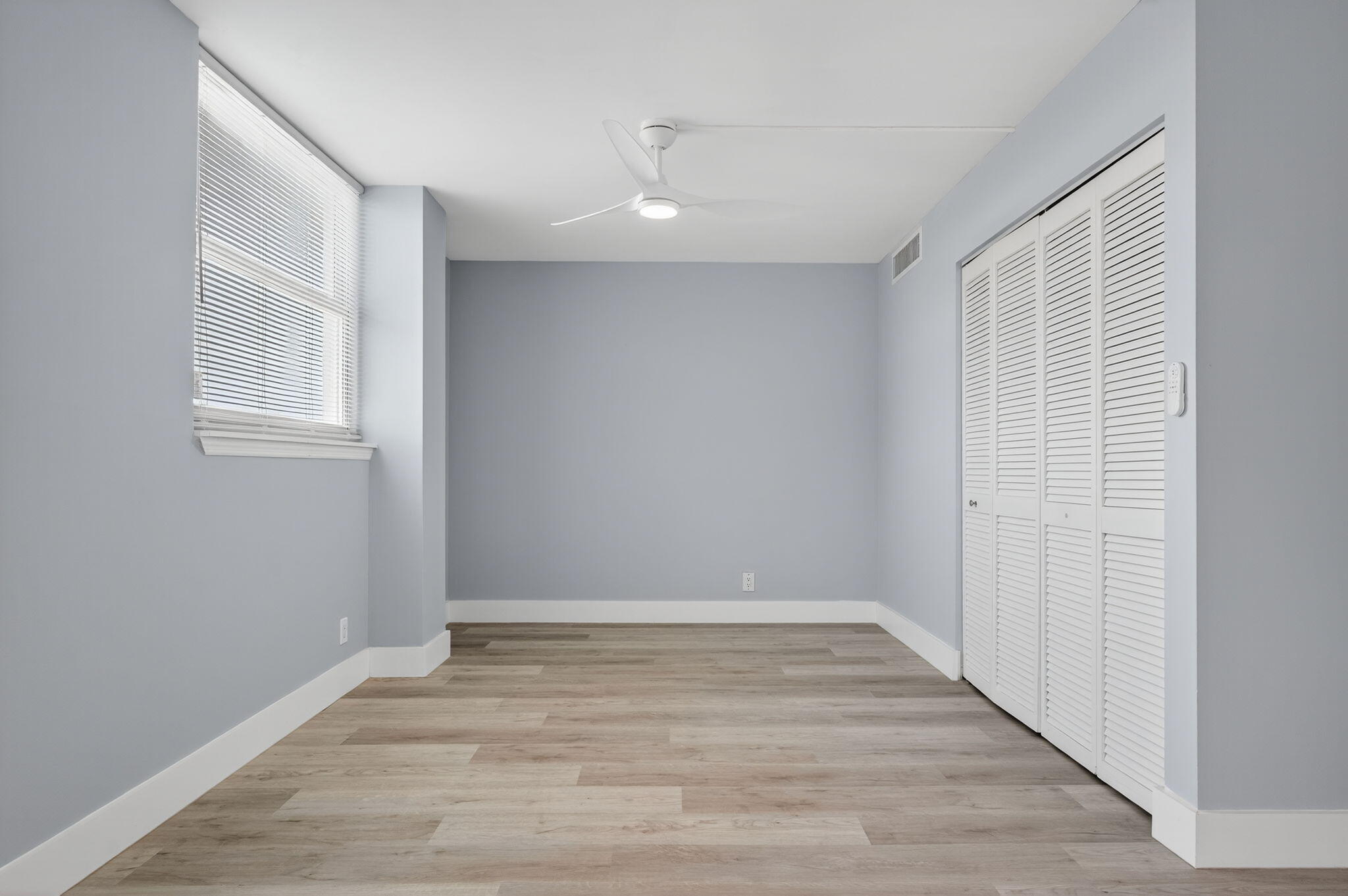 5500 Northwest 2nd Avenue, Unit 314 Boca Raton, FL 33487 - Photo 24 of 35 a view of an empty room with wooden floor and a window