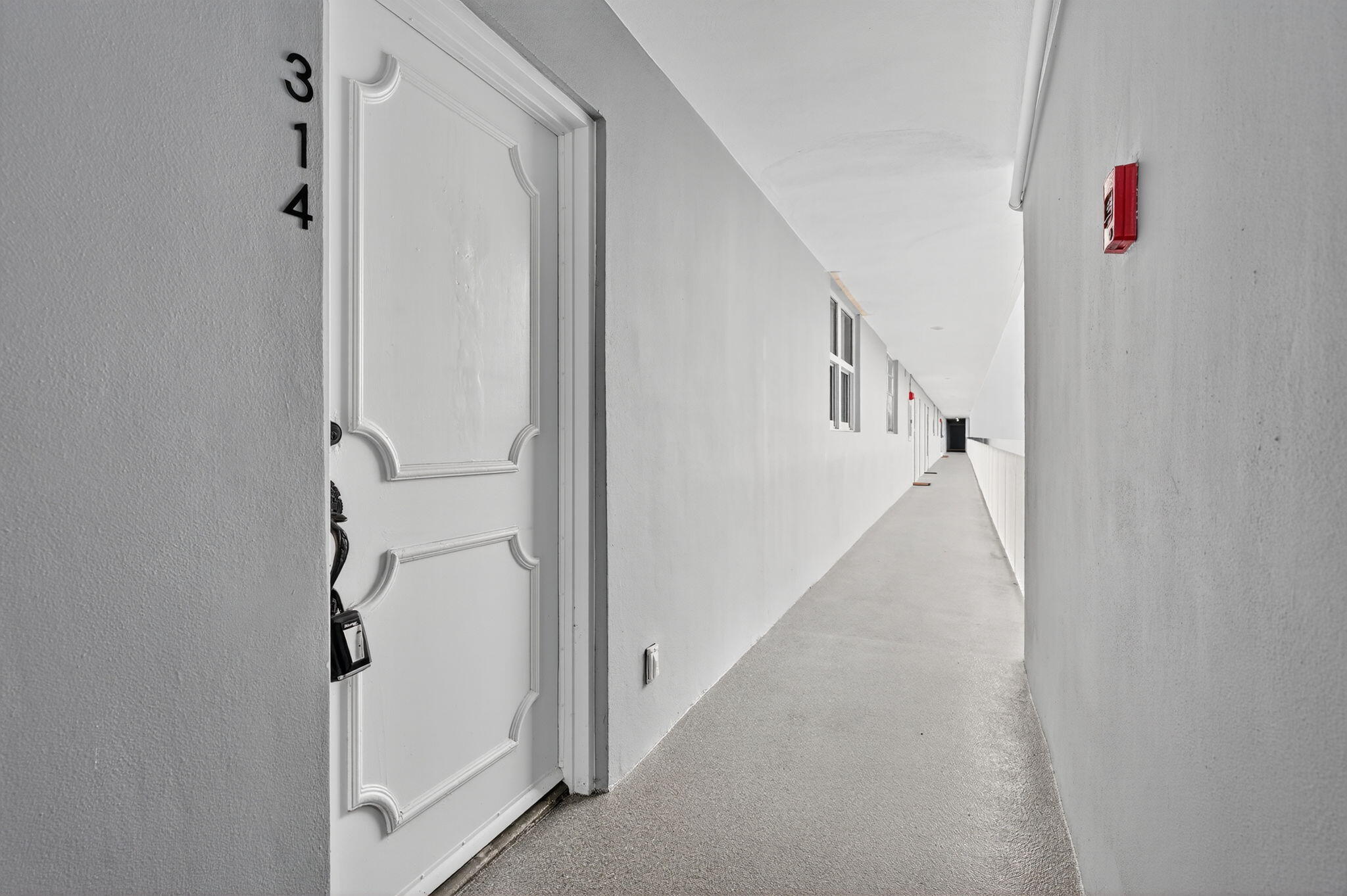 5500 Northwest 2nd Avenue, Unit 314 Boca Raton, FL 33487 - Photo 34 of 35 a view of a hallway with white walls
