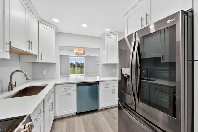 a kitchen with stainless steel appliances a refrigerator sink and cabinets