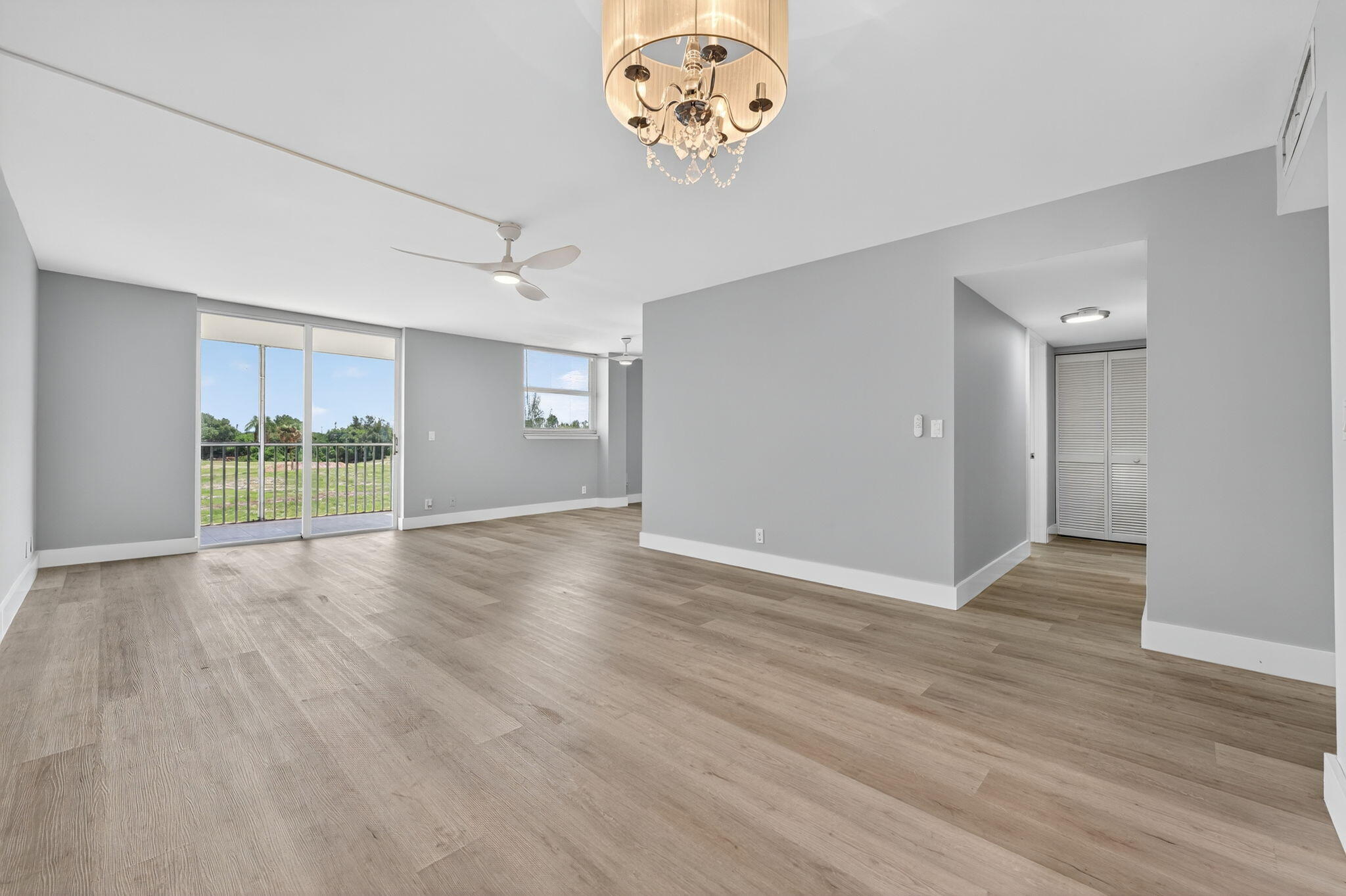 5500 Northwest 2nd Avenue, Unit 314 Boca Raton, FL 33487 - Photo 7 of 35 an empty room with wooden floor and windows