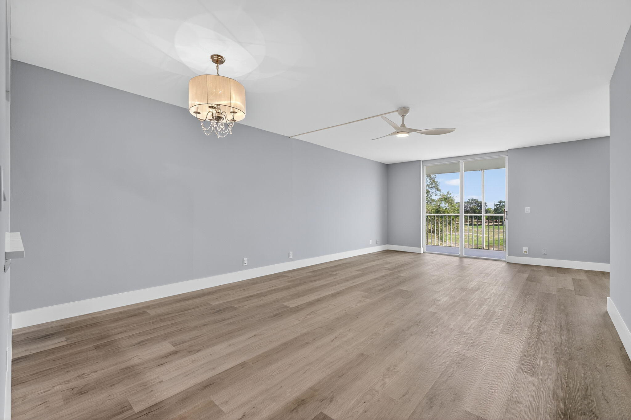 5500 Northwest 2nd Avenue, Unit 314 Boca Raton, FL 33487 - Photo 9 of 35 an empty room with wooden floor and windows