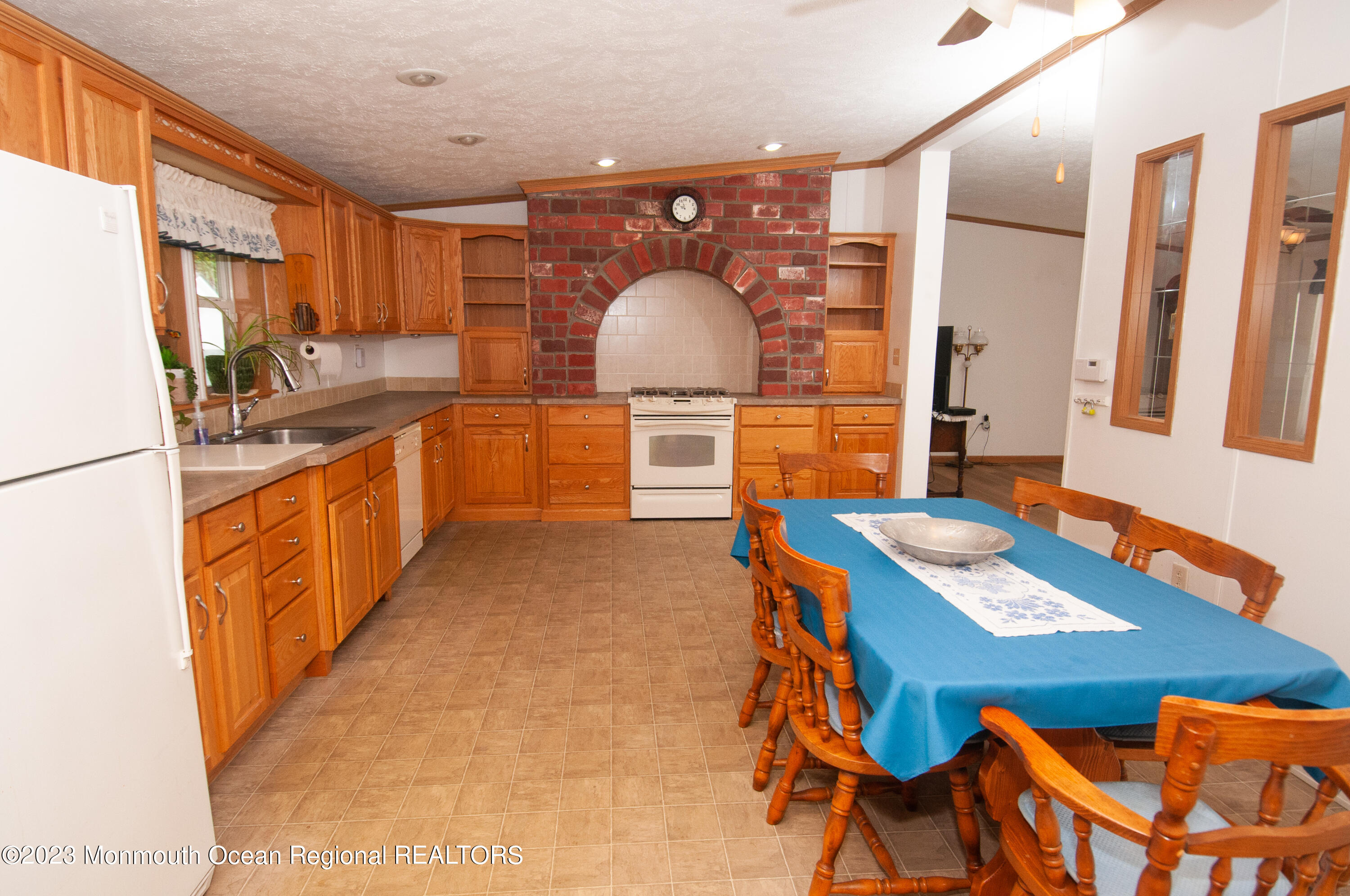 116 Woody Road Freehold, NJ 07728 - Photo 11 of 33 a kitchen with stainless steel appliances kitchen island granite countertop a stove a sink and a refrigerator
