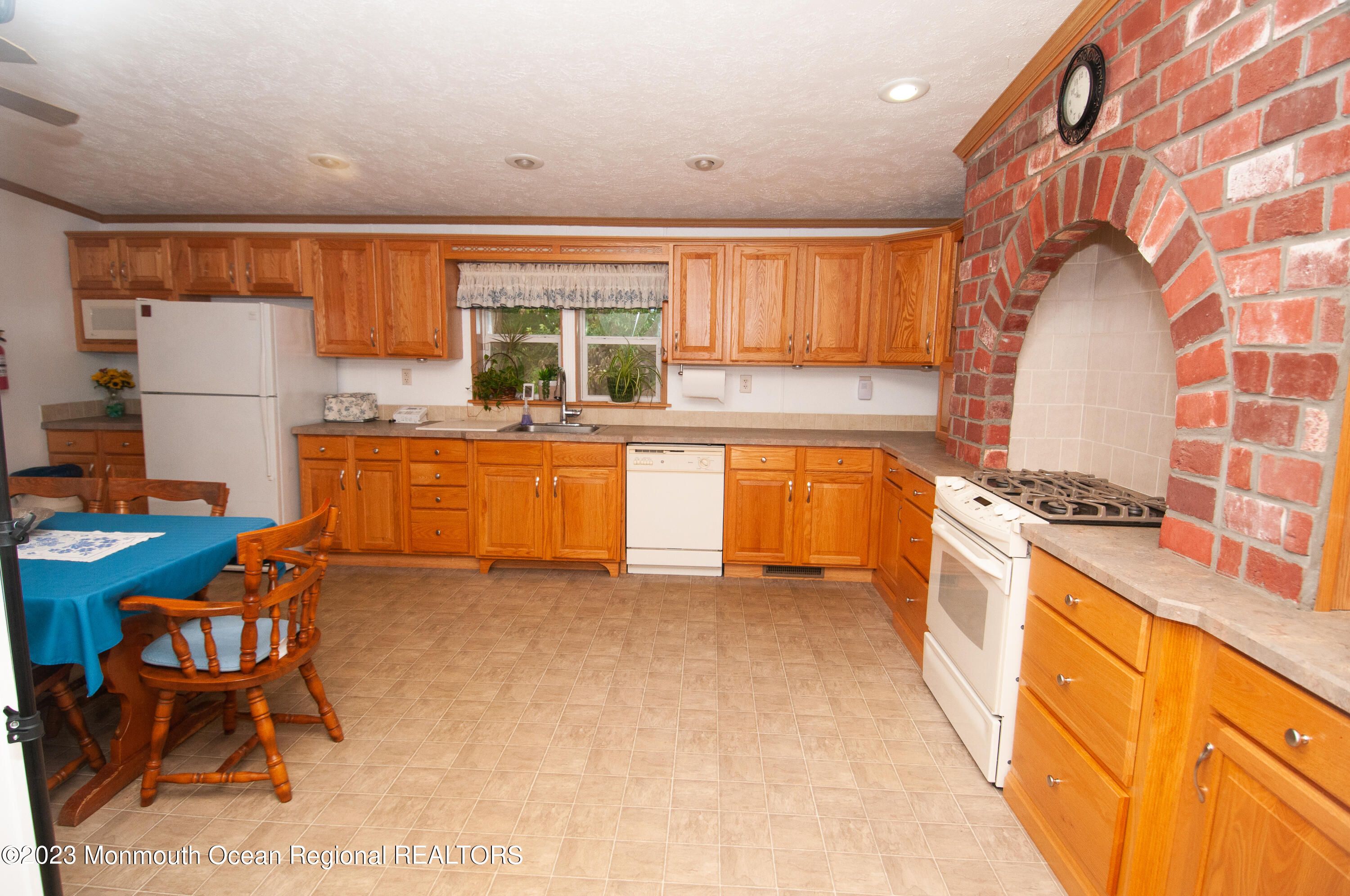 116 Woody Road Freehold, NJ 07728 - Photo 13 of 33 a kitchen with stainless steel appliances granite countertop a stove a sink and a refrigerator