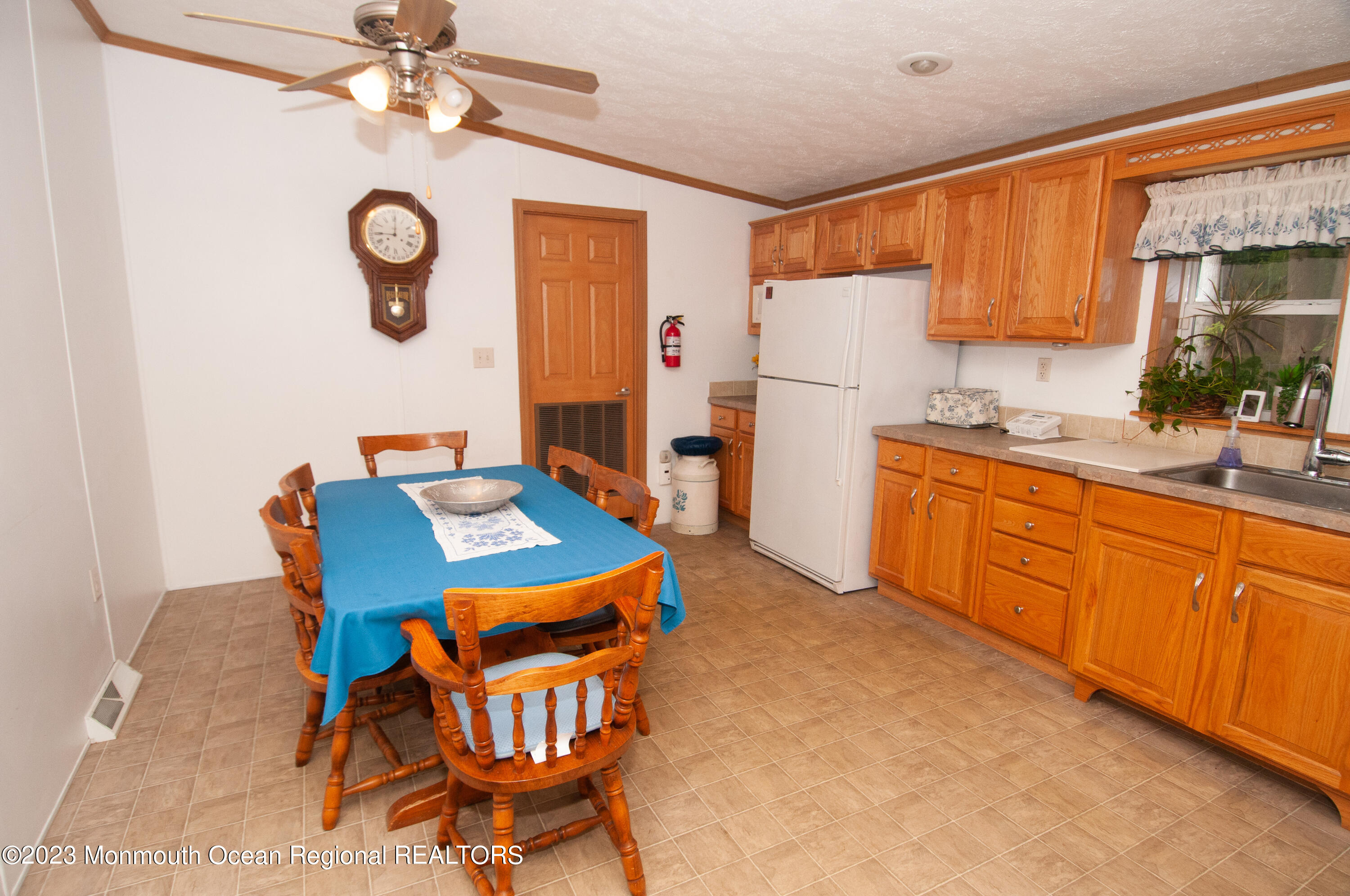 116 Woody Road Freehold, NJ 07728 - Photo 16 of 33 a kitchen with stainless steel appliances a stove a refrigerator a sink dishwasher a dining table and chairs with wooden floor