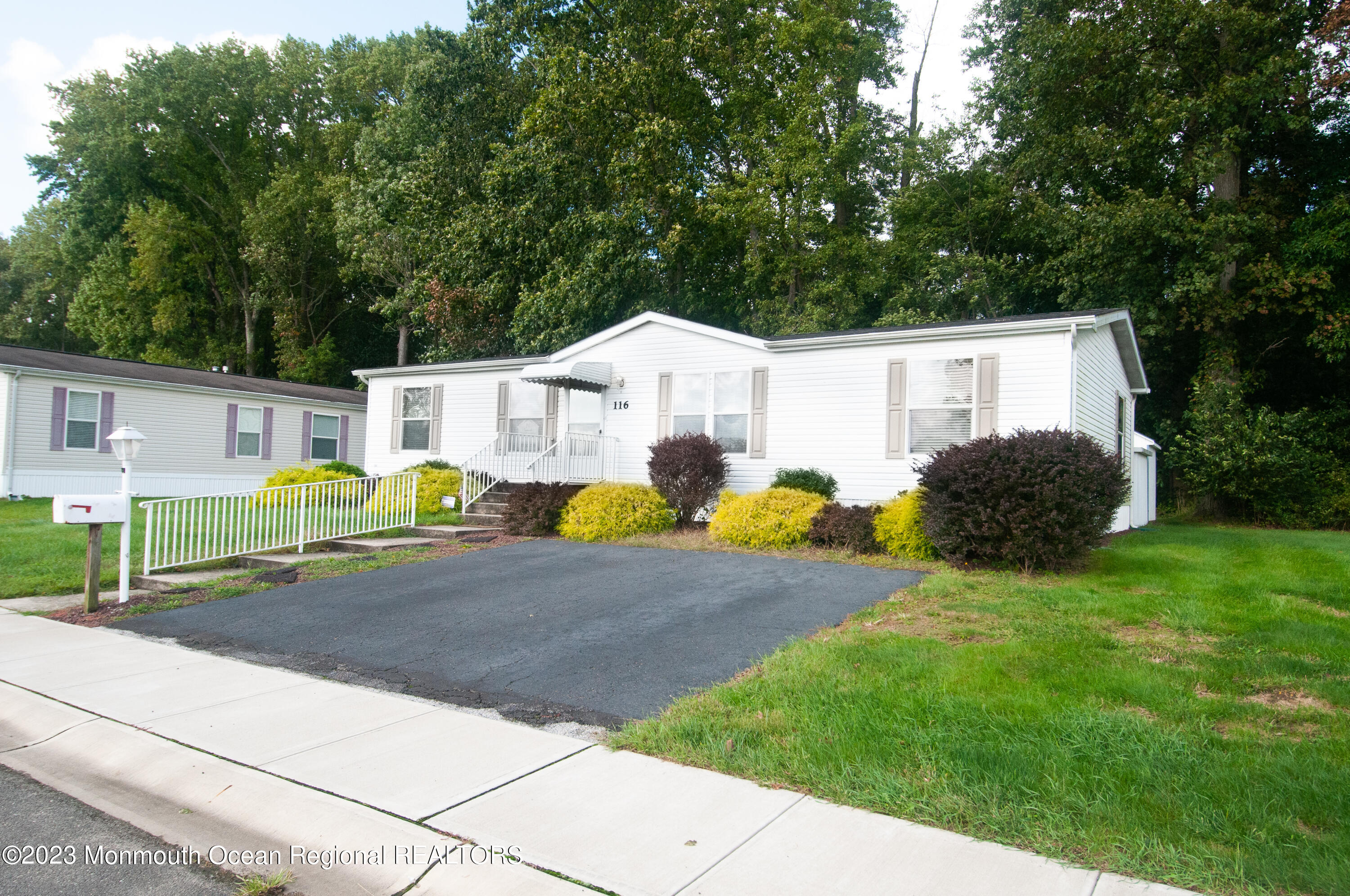 116 Woody Road Freehold, NJ 07728 - Photo 3 of 33 a backyard of a house with table and chairs