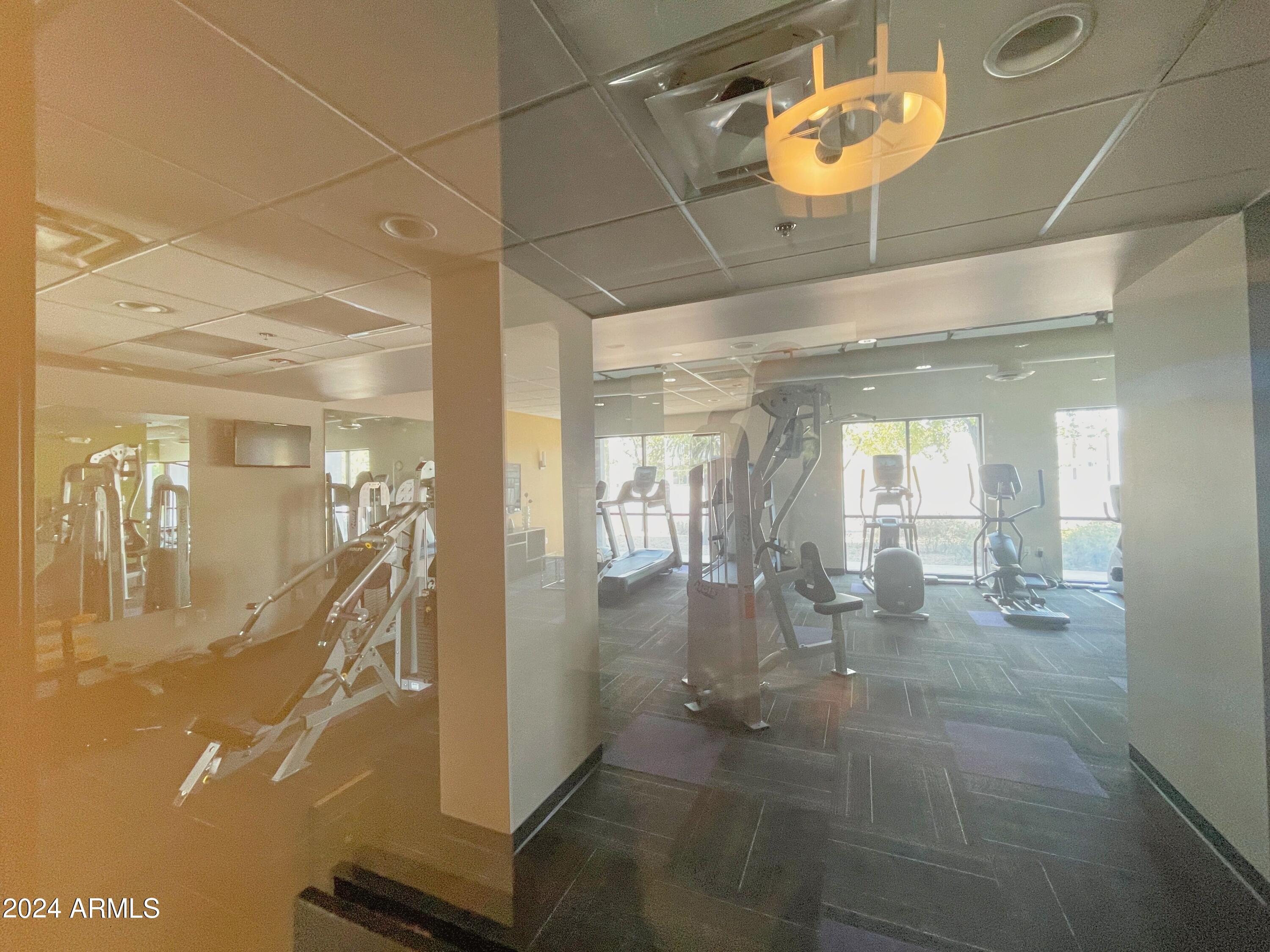 535 West Thomas Road, Unit 401 Phoenix, AZ 85013 - Photo 17 of 22 a view of a hallway with chandelier
