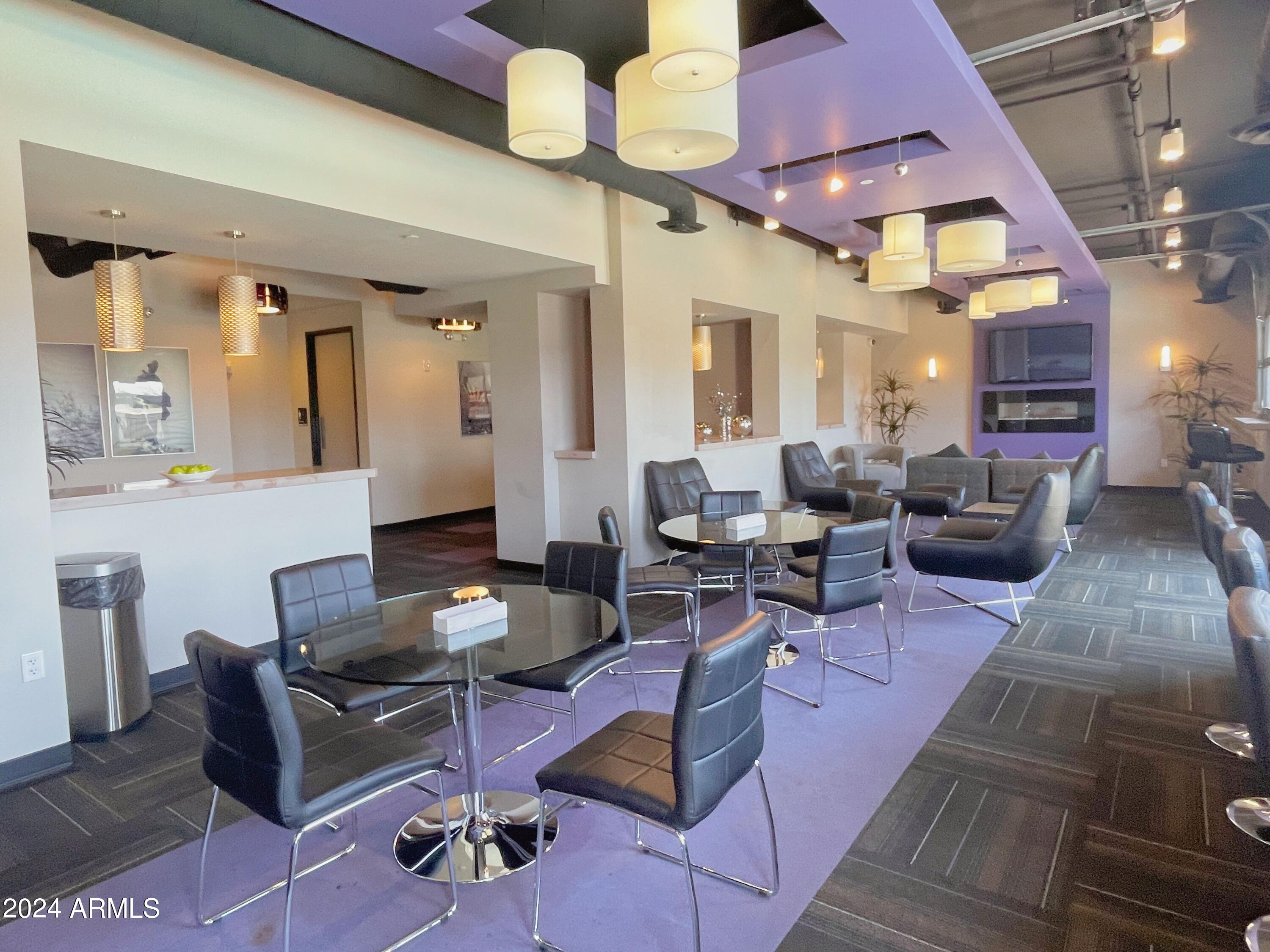 535 West Thomas Road, Unit 401 Phoenix, AZ 85013 - Photo 20 of 22 a living room with furniture a rug and a chandelier