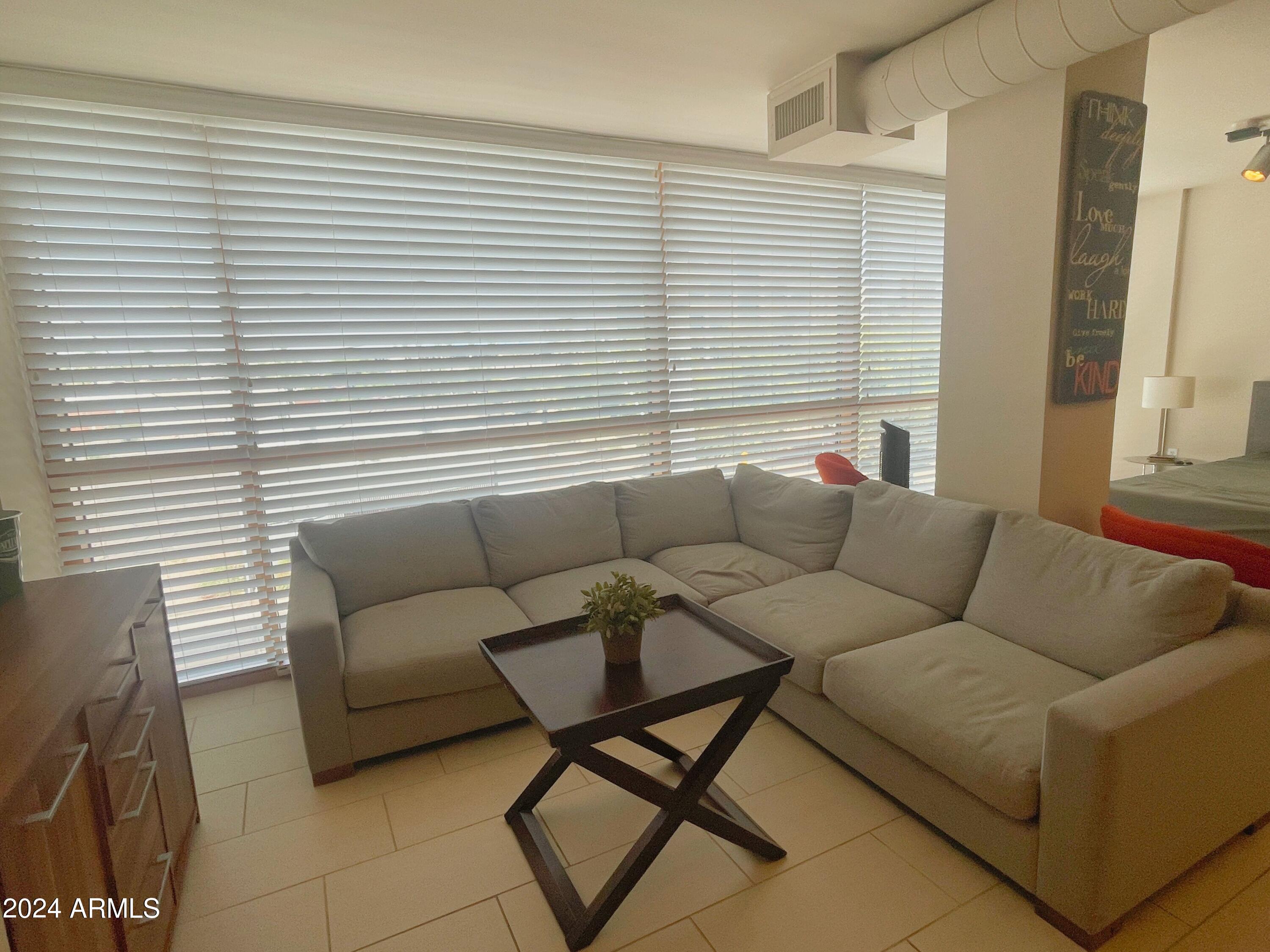 535 West Thomas Road, Unit 401 Phoenix, AZ 85013 - Photo 8 of 22 a living room with furniture and a window