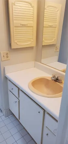 a bath tub sitting next to a white sink