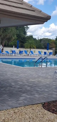 a view of swimming pool with outdoor seating