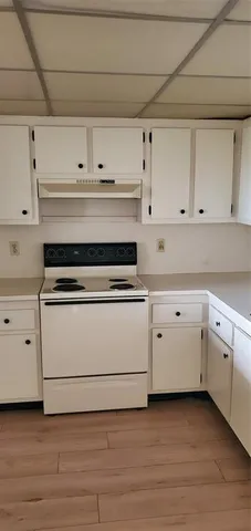 a kitchen with white cabinets and a sink