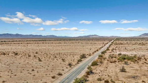 a view of an ocean beach and mountain