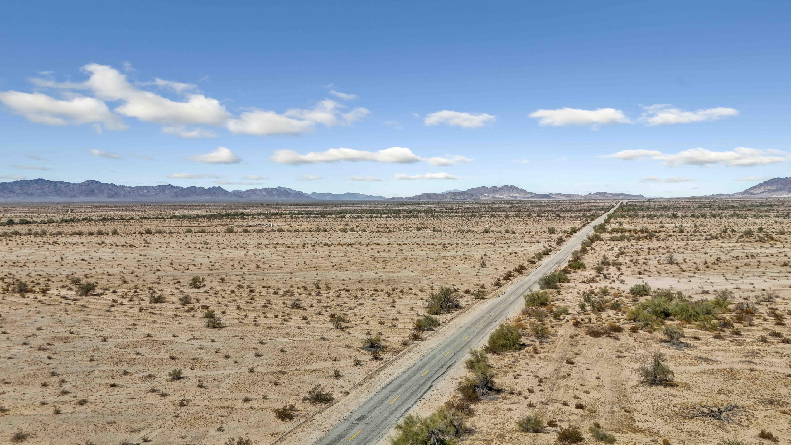 a view of an ocean beach and mountain