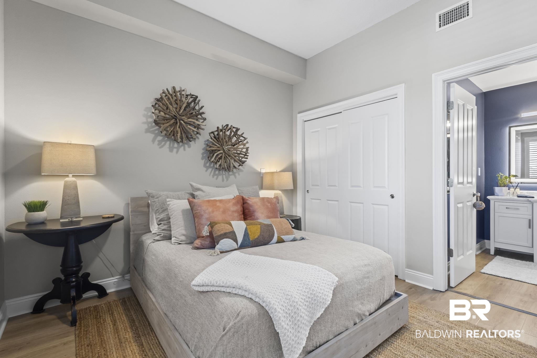 28250 Canal Road, Unit 403 Orange Beach, AL 36561 - Photo 20 of 54 Bedroom featuring light wood-style floors, a closet, and ensuite bathroom