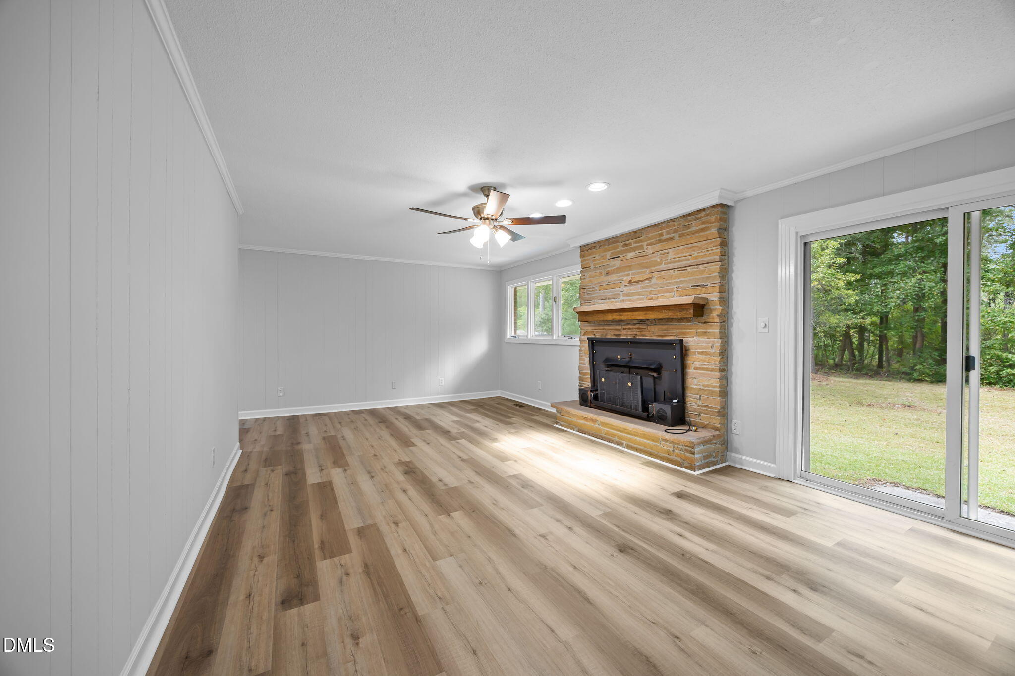 1341 Bear Trap Road Williamston, NC 27892 - Photo 11 of 42 wooden floor in an empty room with a fireplace