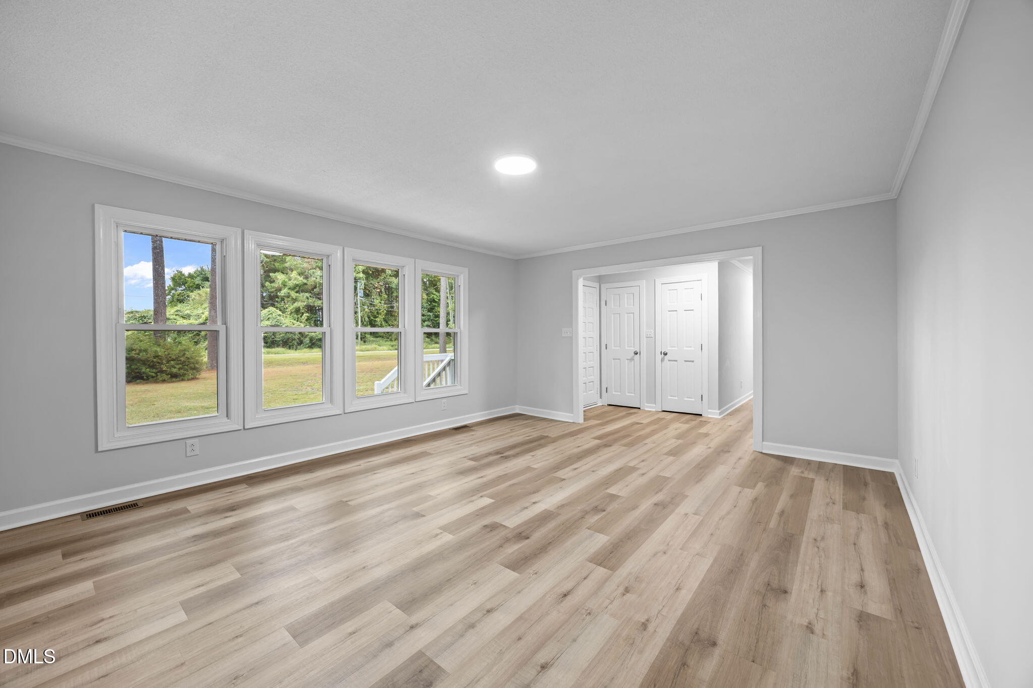 1341 Bear Trap Road Williamston, NC 27892 - Photo 6 of 42 a view of an empty room with wooden floor and a window