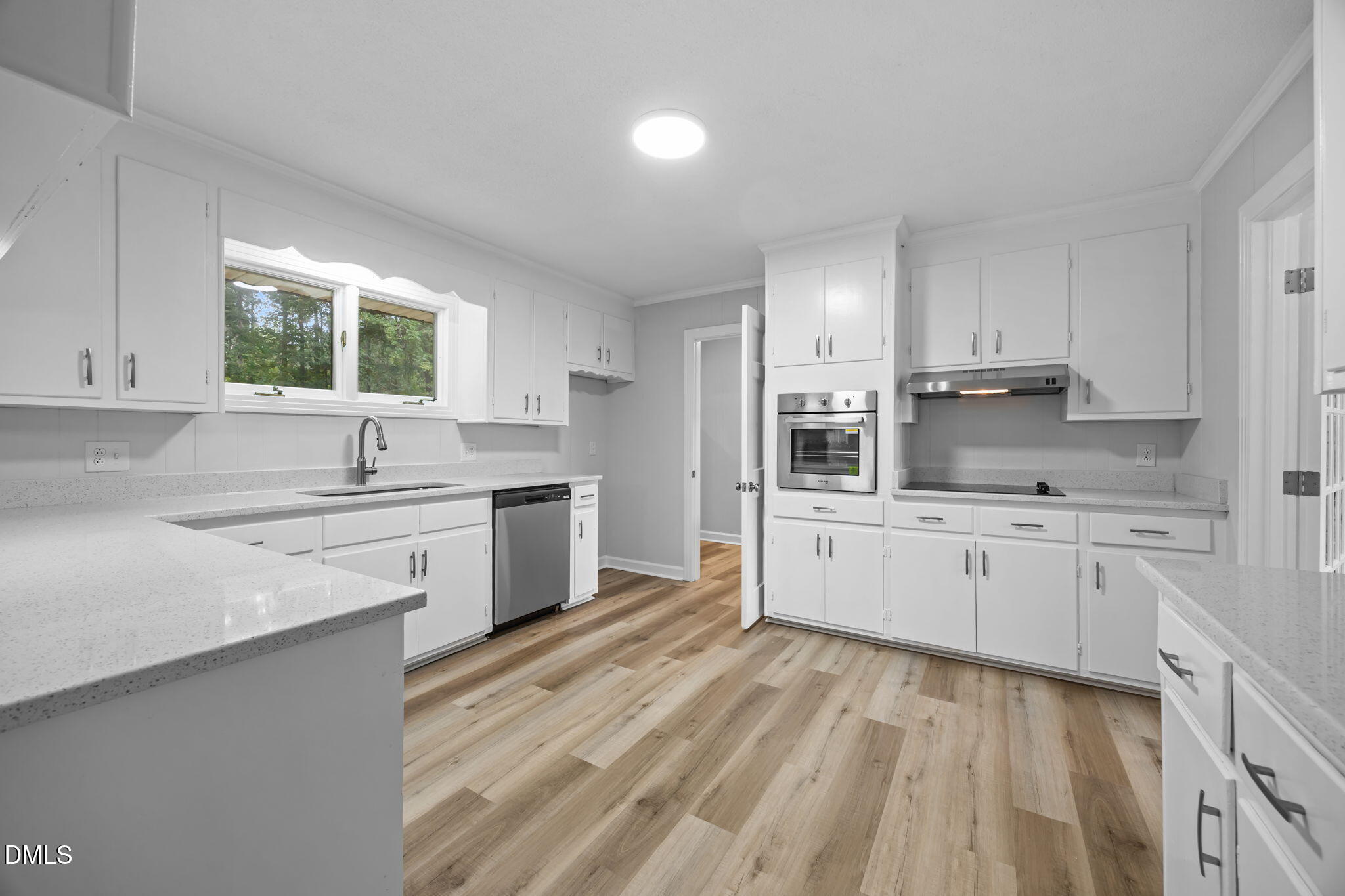1341 Bear Trap Road Williamston, NC 27892 - Photo 9 of 42 a kitchen with granite countertop white cabinets a sink a window and stainless steel appliances