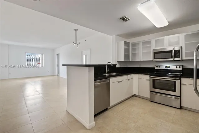 a kitchen with a refrigerator stove and sink