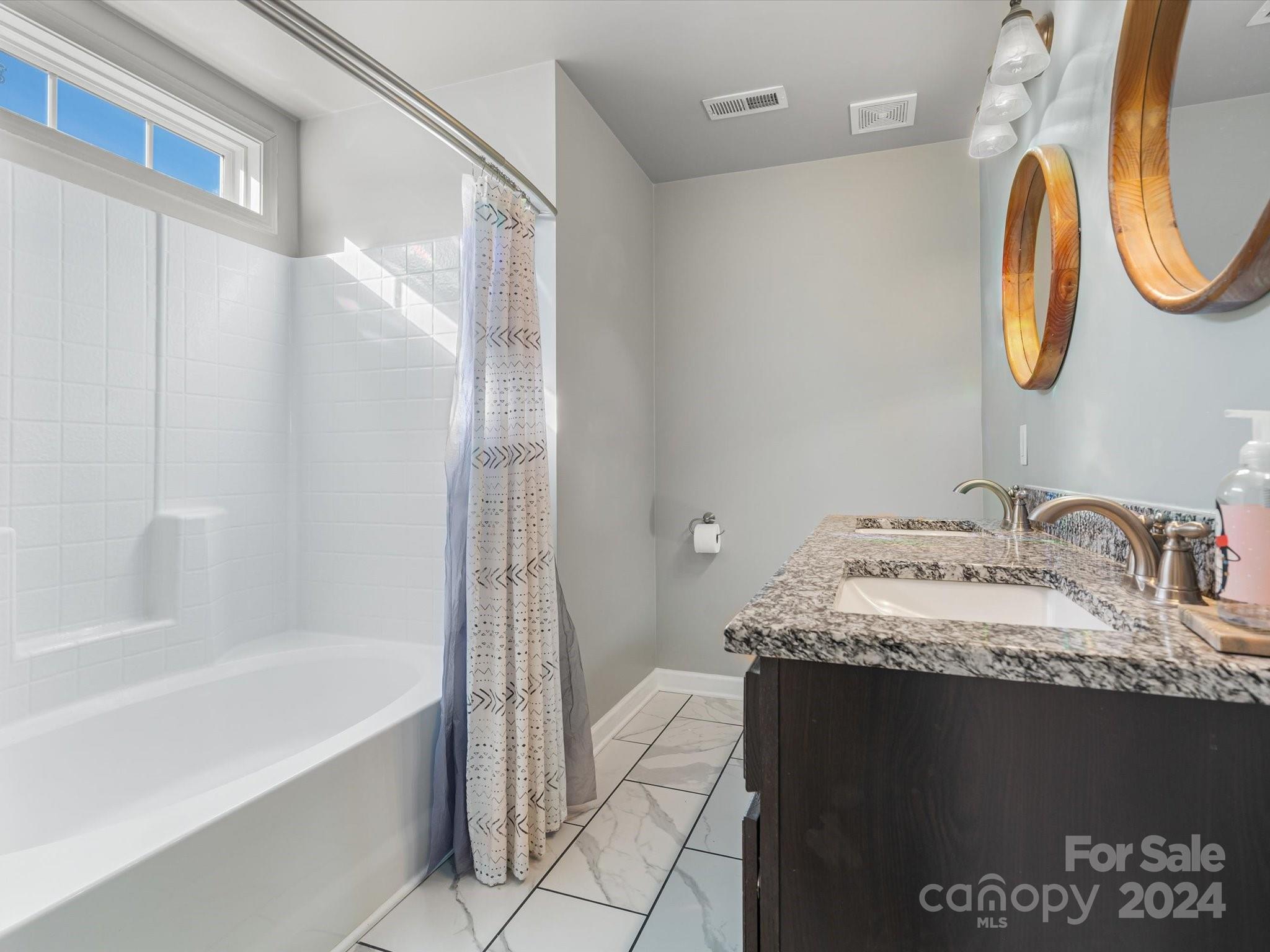 1128 State Rd S-46-817 York, SC 29745 - Photo 12 of 22 a bathroom with a granite countertop sink a mirror and a bathtub